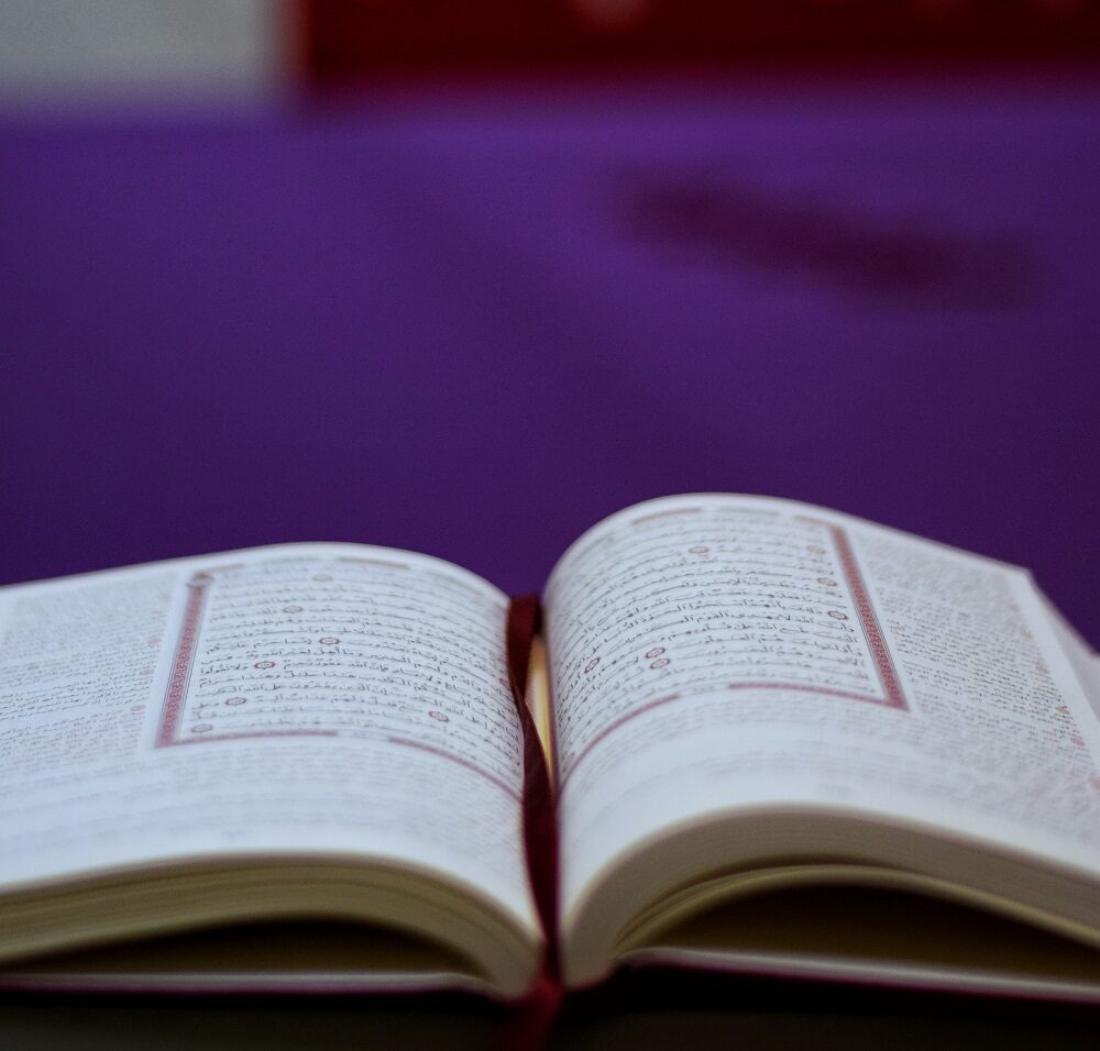 An open Qur’an on a reading stand